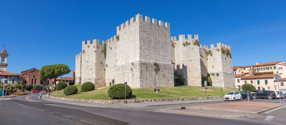 Die Außenansicht zeigt strenge staufische Formen, helle Steinmauern und mächtige Türme als Zeichen kaiserlicher Macht.