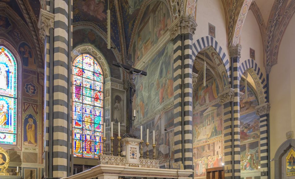 Die Glasfenster tauchen den Innenraum in farbiges Licht und verbinden religiöse Symbolik mit feiner Handwerkskunst.